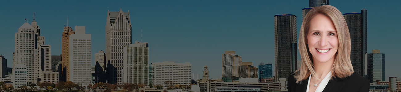 Ellen Michaels smiling in a black business suit, superimposed on a panoramic background of a city skyline with skyscrapers beside a calm body of water under a clear sky.